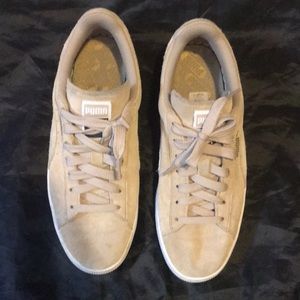 Classic tan Puma sneakers.